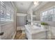 Updated bathroom with marble vanity and herringbone floor at 6737 Lancer Dr, Charlotte, NC 28226