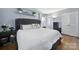 Main bedroom with hardwood floors, gray walls, and a tufted headboard at 6737 Lancer Dr, Charlotte, NC 28226