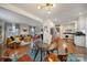 Open concept dining room with glass table and view into living room and kitchen at 6737 Lancer Dr, Charlotte, NC 28226