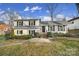 Charming ranch home with white exterior, black shutters, and manicured lawn at 6737 Lancer Dr, Charlotte, NC 28226