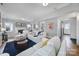 Open living room with white sofas and a view of the kitchen at 6737 Lancer Dr, Charlotte, NC 28226