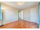 Bedroom with hardwood floors, and access to hallway at 6816 Idlewild Rd, Charlotte, NC 28212