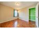 Bedroom with hardwood floors, window, and green accent wall at 6816 Idlewild Rd, Charlotte, NC 28212