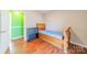 Small bedroom with wood flooring and a double bed at 6816 Idlewild Rd, Charlotte, NC 28212