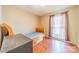 Small bedroom with hardwood floors and a twin bed at 6816 Idlewild Rd, Charlotte, NC 28212