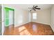 Bright bedroom featuring hardwood floors and ceiling fan at 6816 Idlewild Rd, Charlotte, NC 28212