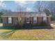 Brick ranch house with a neat lawn and shrubs at 6816 Idlewild Rd, Charlotte, NC 28212