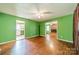 Living room with hardwood floors, green walls, and fireplace at 6816 Idlewild Rd, Charlotte, NC 28212