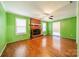 Living room with hardwood floors, green walls, and fireplace at 6816 Idlewild Rd, Charlotte, NC 28212