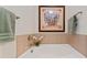 Soaking tub with updated tile and frameless mirror at 804 Skybrook Falls Dr, Huntersville, NC 28078