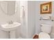 Clean and updated half bathroom with pedestal sink and toilet at 804 Skybrook Falls Dr, Huntersville, NC 28078