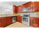 Modern kitchen features stainless steel appliances and rich wood cabinets at 804 Skybrook Falls Dr, Huntersville, NC 28078