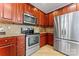 Stainless steel appliances and ample wood cabinetry in kitchen at 804 Skybrook Falls Dr, Huntersville, NC 28078