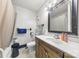 Cozy bathroom features a wooden vanity, square mirror and tiled floors at 901 Maple Ave, Salisbury, NC 28144