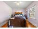 Comfortable bedroom with hardwood floors, two windows, and neutral wall paint at 901 Maple Ave, Salisbury, NC 28144