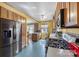 Kitchen featuring wood cabinets, stainless steel appliances, and eat-in breakfast area at 901 Maple Ave, Salisbury, NC 28144