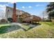 Spacious deck with pergola, steps leading to a grassy backyard with a partial snow dusting at 9236 Silver Pine Dr, Charlotte, NC 28277