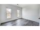 Bright bedroom with gray flooring and two large windows at 9236 Silver Pine Dr, Charlotte, NC 28277