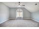 Bright bedroom with gray carpet and arched window at 9236 Silver Pine Dr, Charlotte, NC 28277