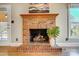 Brick fireplace with wood mantle in a living room at 9236 Silver Pine Dr, Charlotte, NC 28277