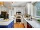 Updated kitchen featuring white cabinets, an island, and stainless steel appliances at 9236 Silver Pine Dr, Charlotte, NC 28277