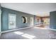 Light-filled living room with gray walls and carpet at 9236 Silver Pine Dr, Charlotte, NC 28277