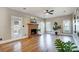 Living room featuring hardwood floors, a brick fireplace, and a view to the backyard at 9236 Silver Pine Dr, Charlotte, NC 28277