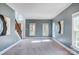 Open living area with gray walls, carpet, and stairs at 9236 Silver Pine Dr, Charlotte, NC 28277