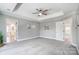 Main bedroom with gray walls, ceiling fan, and carpet at 9236 Silver Pine Dr, Charlotte, NC 28277