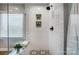 Walk-in shower with subway tile, built-in shelves, and patterned floor at 9236 Silver Pine Dr, Charlotte, NC 28277