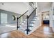 Modern black railing staircase with hardwood floors at 9236 Silver Pine Dr, Charlotte, NC 28277