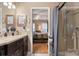 Bathroom with double vanity and view into the bedroom at 10122 Oxford Landing Ln, Charlotte, NC 28270