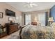 Main bedroom with hardwood floors, dresser, and large TV at 10122 Oxford Landing Ln, Charlotte, NC 28270