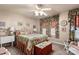 Well-lit bedroom featuring floral bedding and a convenient vanity area at 10122 Oxford Landing Ln, Charlotte, NC 28270