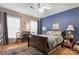 Main bedroom with a ceiling fan, large windows, and hardwood floors at 10122 Oxford Landing Ln, Charlotte, NC 28270