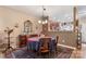 Formal dining area with hardwood floor, a charming table setting, and fireplace at 10122 Oxford Landing Ln, Charlotte, NC 28270