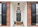 Inviting front entrance with brick facade, black shutters, and a welcoming mat at 10122 Oxford Landing Ln, Charlotte, NC 28270