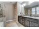 Bathroom with granite countertop, large mirror, and shower at 1026 Slew O Gold Ln, Indian Trail, NC 28079