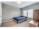 Bright bedroom featuring a double bed and two windows at 1026 Slew O Gold Ln, Indian Trail, NC 28079