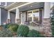 Relaxing front porch with stone accents and lush landscaping at 1026 Slew O Gold Ln, Indian Trail, NC 28079