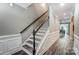 Elegant staircase with dark wood treads and white railing at 1026 Slew O Gold Ln, Indian Trail, NC 28079