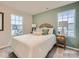 Bright bedroom featuring a double bed, nightstand, and large windows at 117 Mountain Bridge Way, Statesville, NC 28625