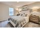 Bright bedroom with a queen bed and neutral decor at 117 Mountain Bridge Way, Statesville, NC 28625