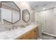 Modern bathroom with double sinks, marble countertop, and glass shower at 12217 Pine Valley Club Dr, Charlotte, NC 28277