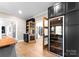 Temperature controlled wine cellar with custom cabinetry at 12217 Pine Valley Club Dr, Charlotte, NC 28277