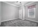 Simple bedroom with grey walls, carpet, and window at 131 E Northstone Rd, Mooresville, NC 28115