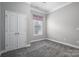 Grey bedroom with window, double door closet, and carpet at 131 E Northstone Rd, Mooresville, NC 28115