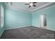 Bright bedroom featuring light blue walls and grey carpet at 131 E Northstone Rd, Mooresville, NC 28115