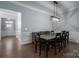 Dining room with dark wood table and chairs, and access to the kitchen at 131 E Northstone Rd, Mooresville, NC 28115