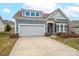 Two-story house with gray siding, stone accents, and a two-car garage at 131 E Northstone Rd, Mooresville, NC 28115